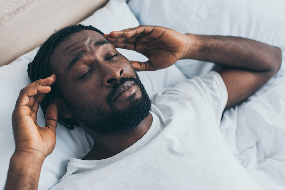African American man suffering headache from lack from sleep-from-chronic-sinusitis