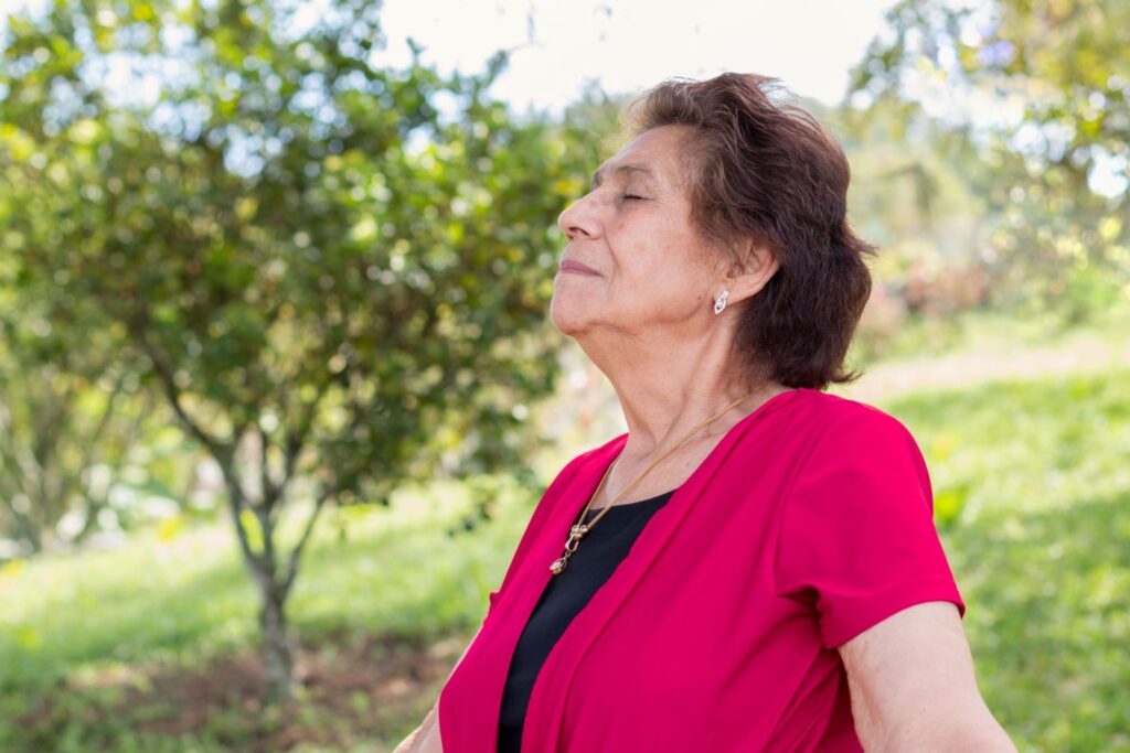 Older Woman Enjoying a Breath of Fresh Air