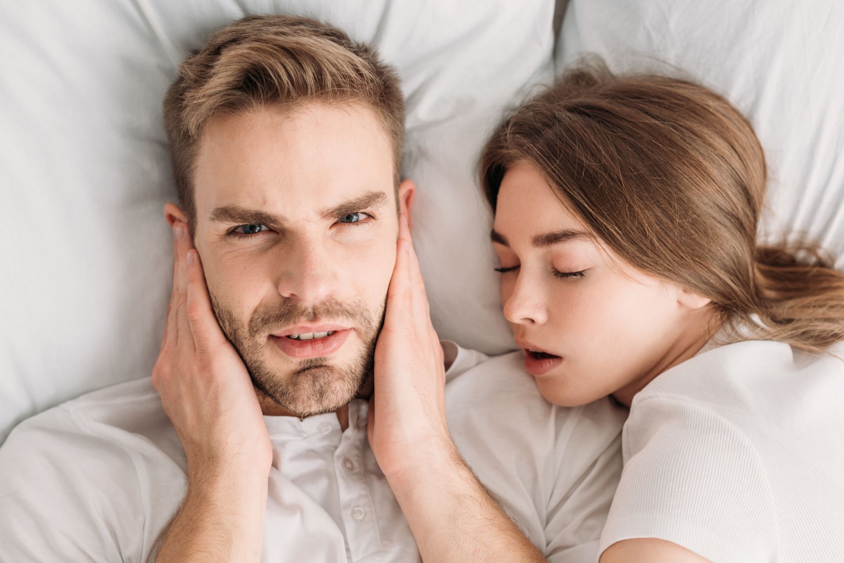 Man unable to sleep because of wife snoring.