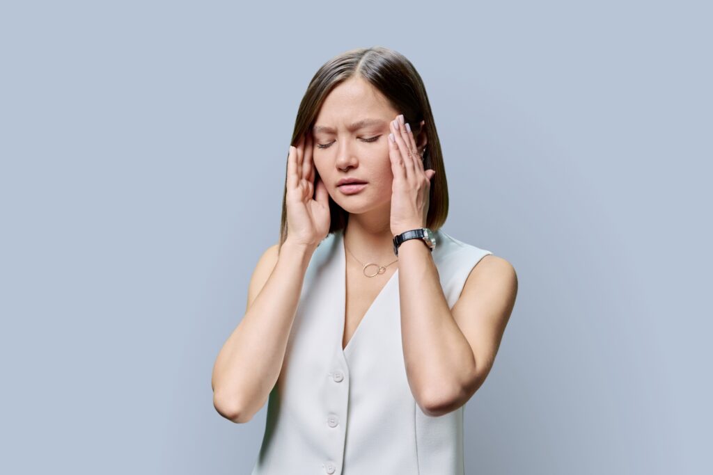 Young woman experiencing stress headache.